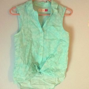 A blue sleeveless flannel top